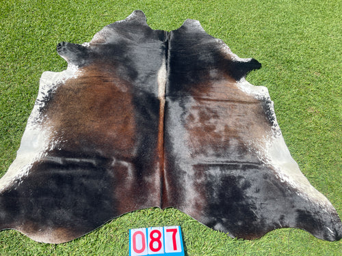 87. Reddish Black and White Cowhide